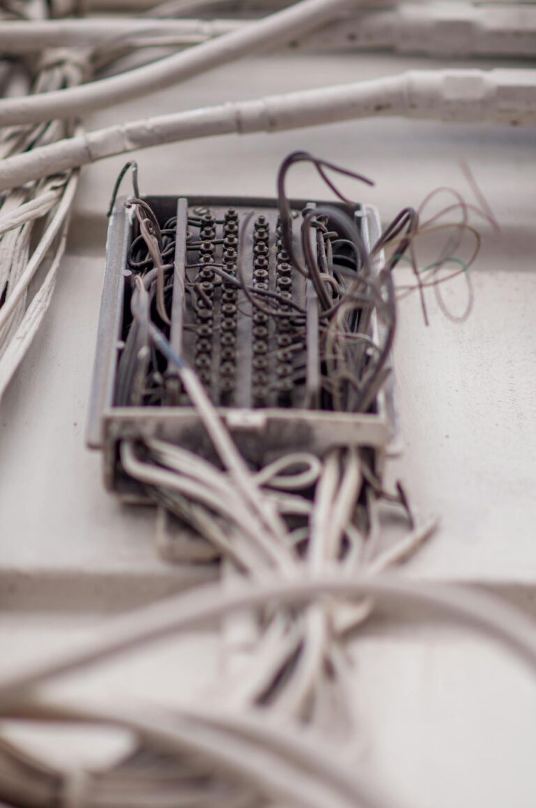 Detailed view of a tangled network of wires in a junction box, illustrating complex wiring.